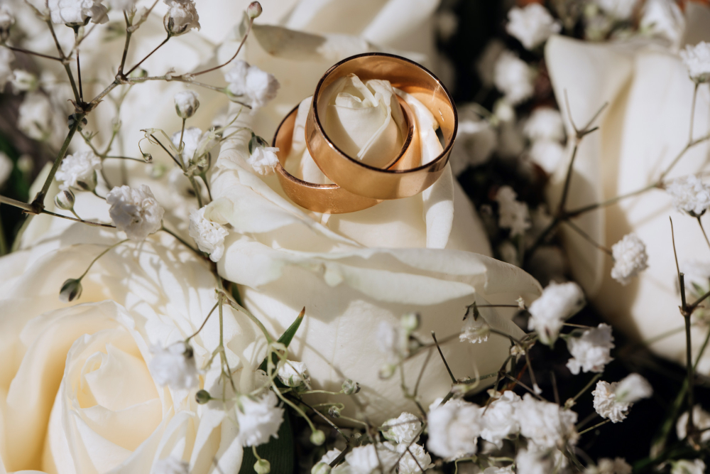 Wedding rings on a floral arrangement representing the process of getting married in Dubai as an expat